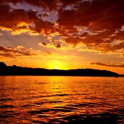 Sun setting behind rocks